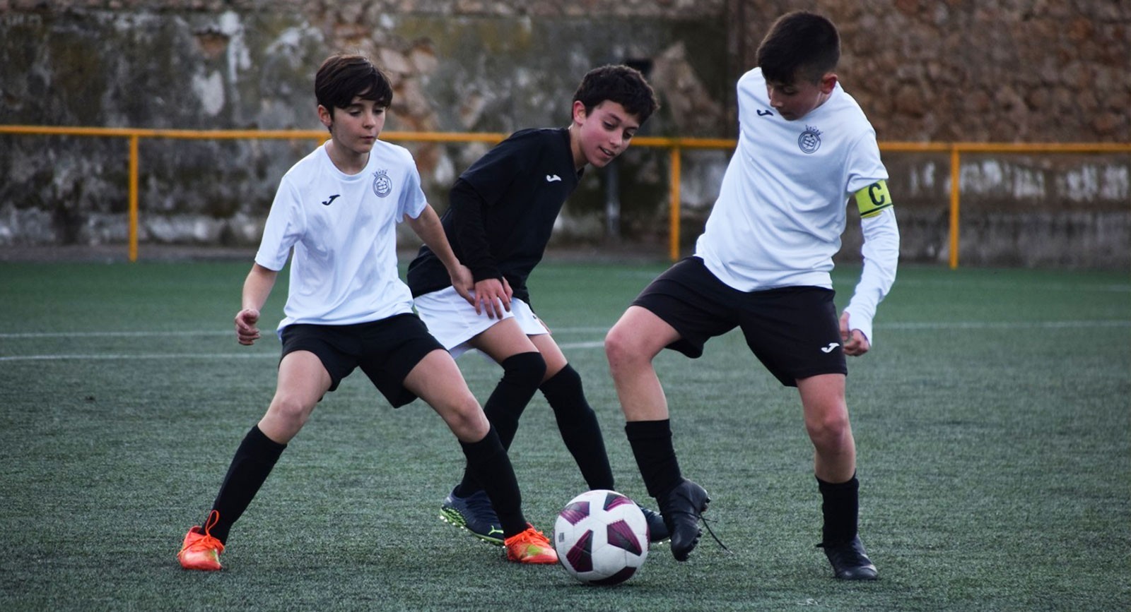 Niños jugando fútbol en la escuela